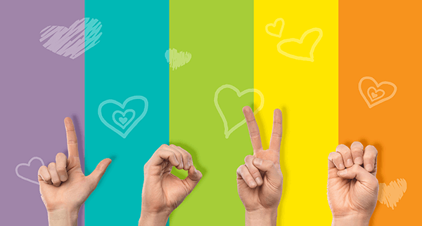 Children using sign language to sign out the word "LOVE" as a form of communication 