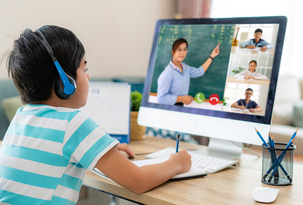 Child on computer learning in virtual learning classroom