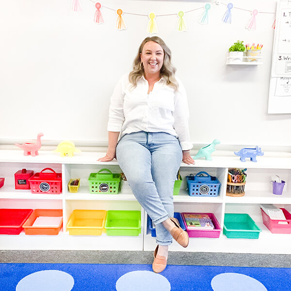 1st Grade Teacher, Bethany Barr sitting in her bright and colorful classroom