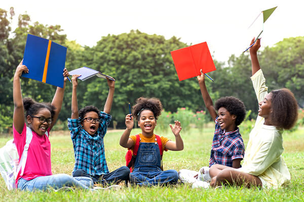 children sitting in the park enjoying learning