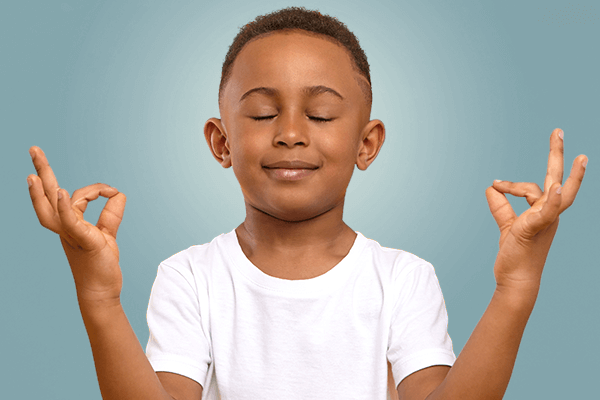 Grade school boy meditating 