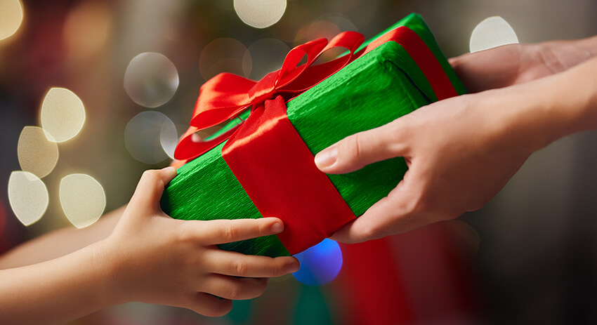 Adult handing gift to child
