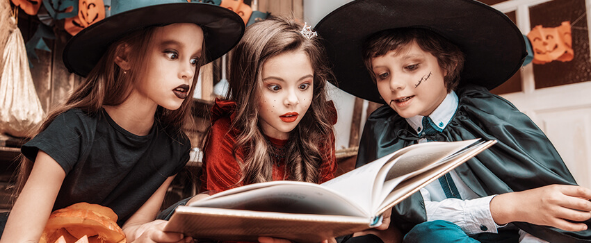 School children in Halloween costumes reading "How to Be Friends with This Werewolf"