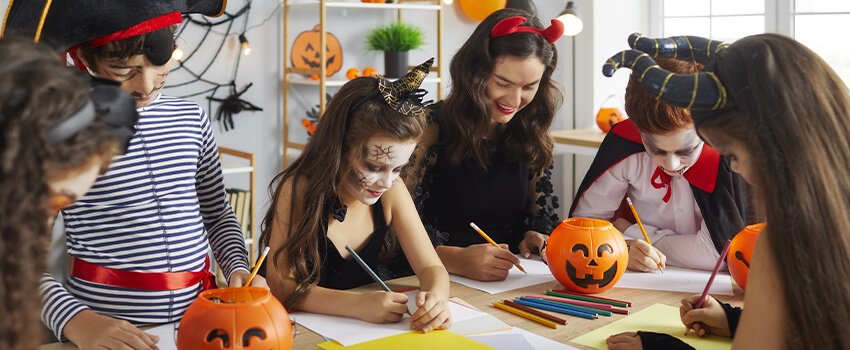 Students in classroom dressed in costumes working on Free Carson Dellosa Halloween Printables