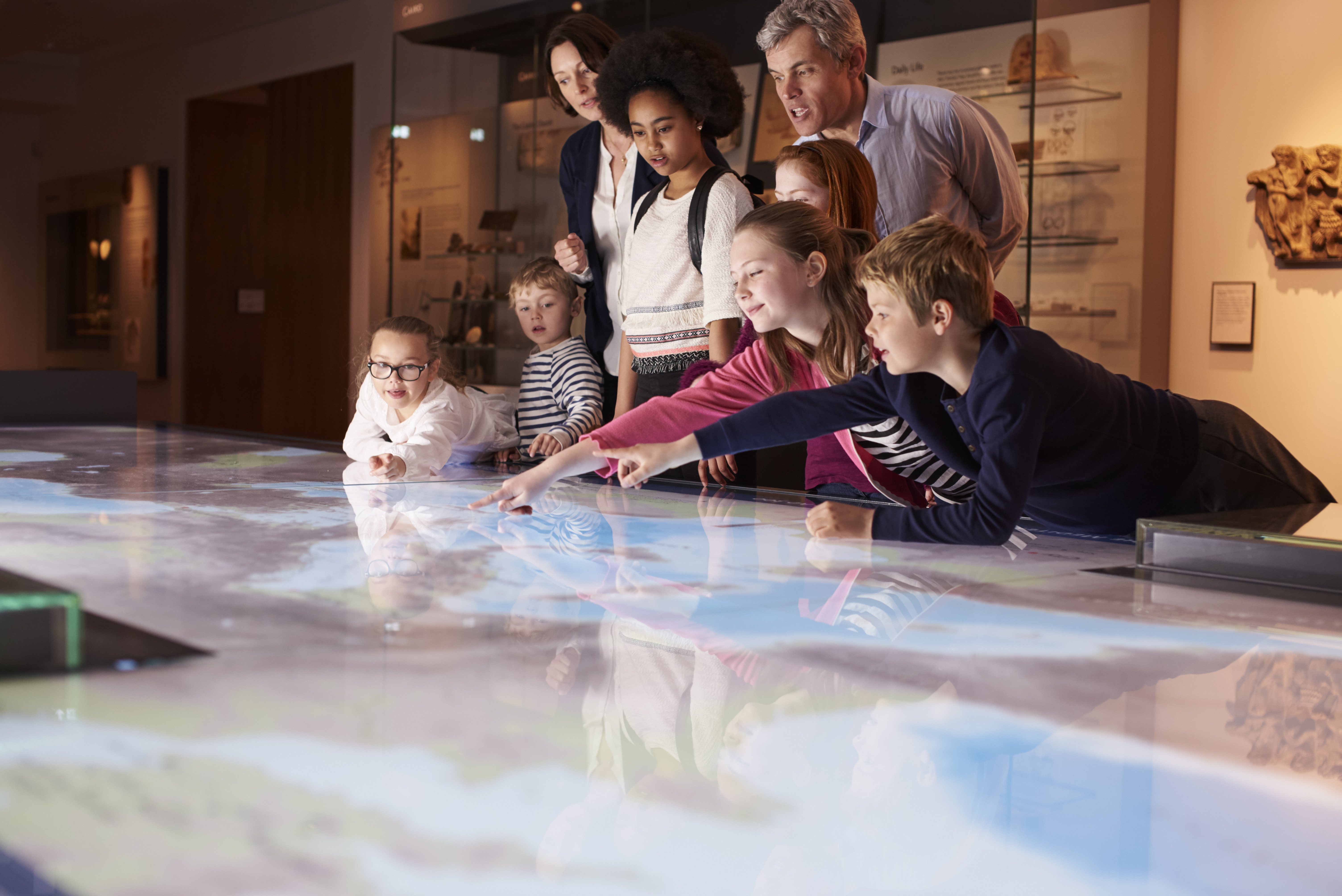 Students, teachers and parents on a field trip in a museum